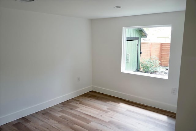 545 W Vaughan St, Bertram, TX 78605 - spare room with wood finished floors and baseboards