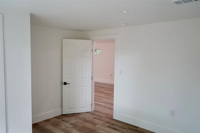 545 W Vaughan St, Bertram, TX 78605 - spare room with wood finished floors and a smoke detector