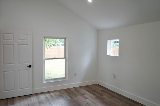 545 W Vaughan St, Bertram, TX 78605 - spare room with healthy amount of natural light, vaulted ceiling, and wood finished floors