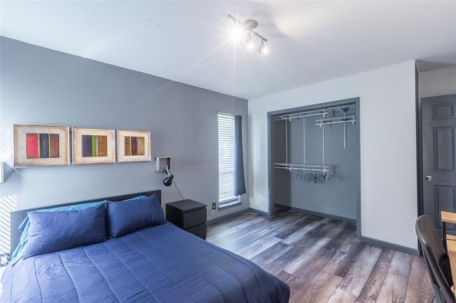 3431 N Hills Dr Unit 115, Austin, TX 78731 - bedroom featuring wood finished floors, rail lighting, and a closet