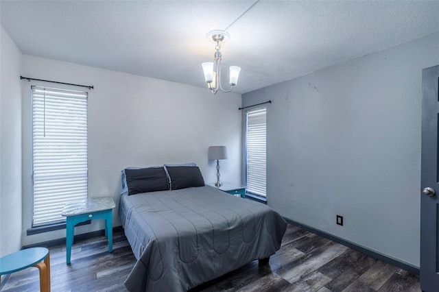 3431 N Hills Dr Unit 115, Austin, TX 78731 - bedroom featuring wood finished floors, multiple windows, and a chandelier