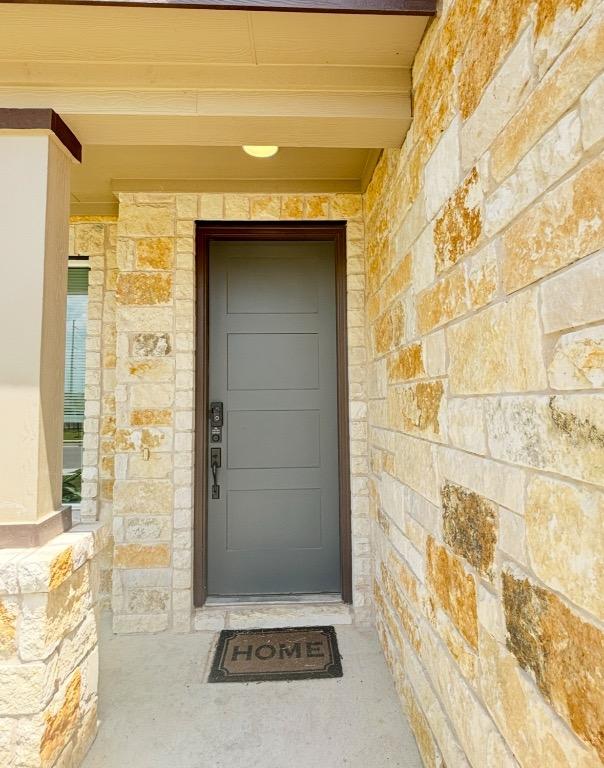 12637 Orchard Grove Ln, Manor, TX 78653 - view of exterior entry featuring stone siding