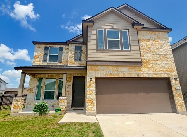 12637 Orchard Grove Ln, Manor, TX 78653 - view of front of home featuring stone siding, an attached garage, and driveway