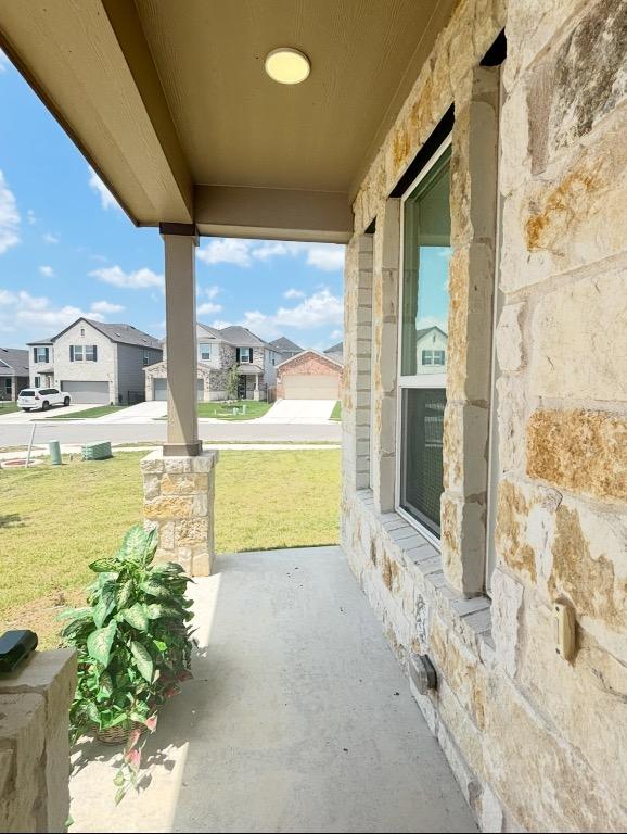12637 Orchard Grove Ln, Manor, TX 78653 - porch featuring a residential view and a lawn