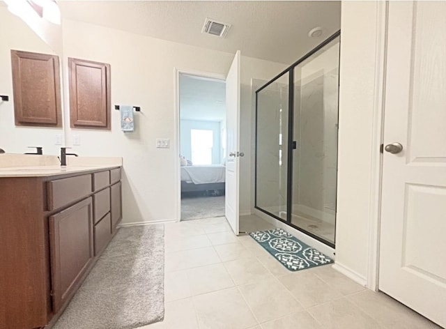 12637 Orchard Grove Ln, Manor, TX 78653 - ensuite bathroom featuring vanity, a shower stall, and tile patterned floors