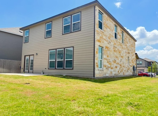 12637 Orchard Grove Ln, Manor, TX 78653 - rear view of house with stone siding and a patio