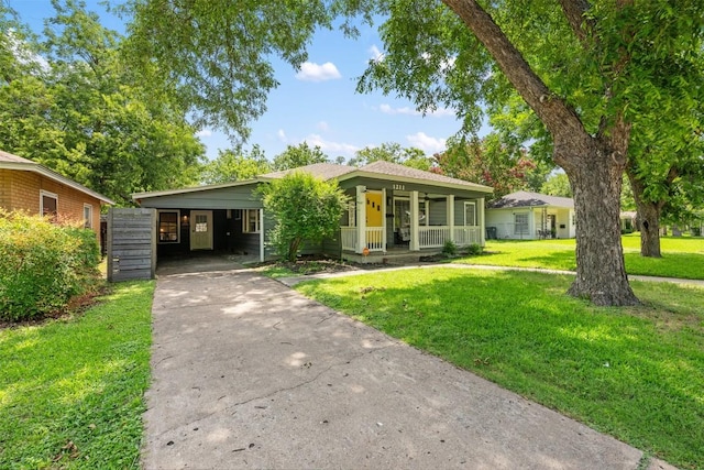 1211 S Church St, Georgetown, TX 78626 - view of front of property featuring covered porch, a front lawn, driveway, and an attached carport