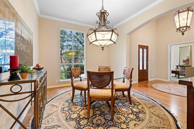 9920 Michelle Hl, Garden Ridge, TX 78266 - dining room with plenty of natural light, light wood finished floors, arched walkways, and ornamental molding