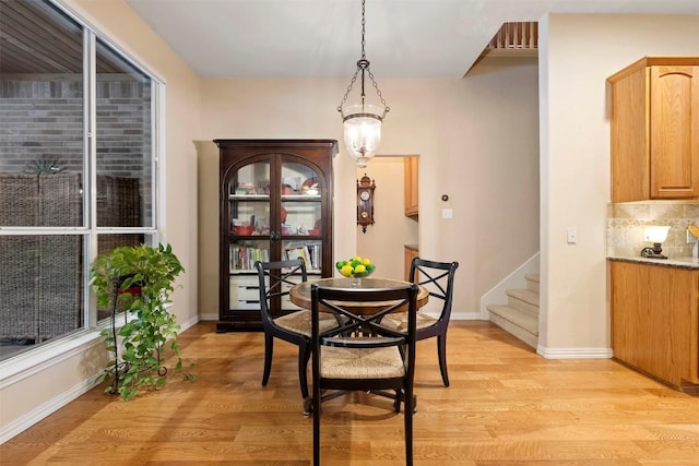 9920 Michelle Hl, Garden Ridge, TX 78266 - dining area with light wood-style flooring and stairway
