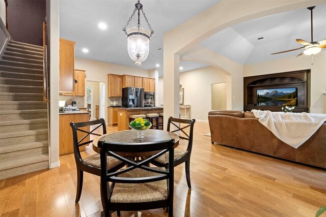 9920 Michelle Hl, Garden Ridge, TX 78266 - dining space featuring ceiling fan, light wood finished floors, arched walkways, stairs, and recessed lighting