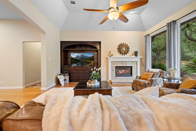 9920 Michelle Hl, Garden Ridge, TX 78266 - living room featuring wood finished floors, vaulted ceiling, a ceiling fan, and a fireplace