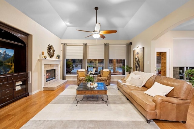 9920 Michelle Hl, Garden Ridge, TX 78266 - living room featuring arched walkways, wood finished floors, a ceiling fan, vaulted ceiling, and a fireplace