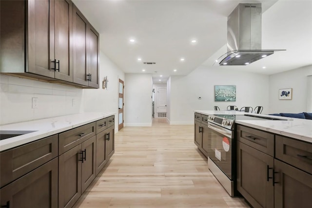 10410 Quail Ridge Dr, Austin, TX 78758 - kitchen featuring island range hood, stainless steel range with electric stovetop, light wood-style flooring, recessed lighting, and light stone counters