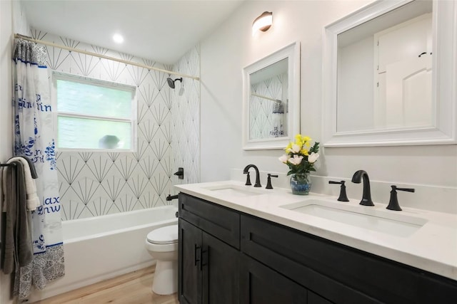 10410 Quail Ridge Dr, Austin, TX 78758 - bathroom featuring double vanity, shower / bathtub combination with curtain, and wood finished floors