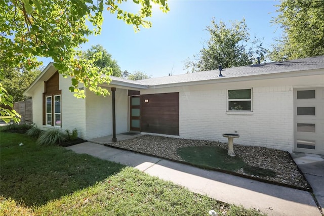 10410 Quail Ridge Dr, Austin, TX 78758 - property entrance featuring brick siding and a lawn