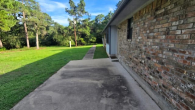 365 Pine Tree Loop, Bastrop, TX 78602 - view of grassy yard with a patio area