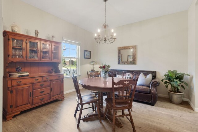 603 Luna Vista Dr, Hutto, TX 78634 - dining space featuring a chandelier and light wood-style flooring