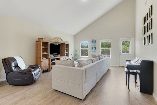 603 Luna Vista Dr, Hutto, TX 78634 - living room with high vaulted ceiling and light wood-style flooring