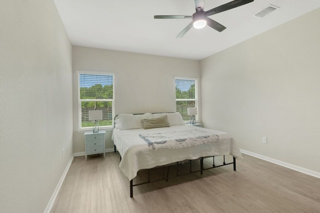 603 Luna Vista Dr, Hutto, TX 78634 - bedroom featuring light wood-style floors, multiple windows, and ceiling fan