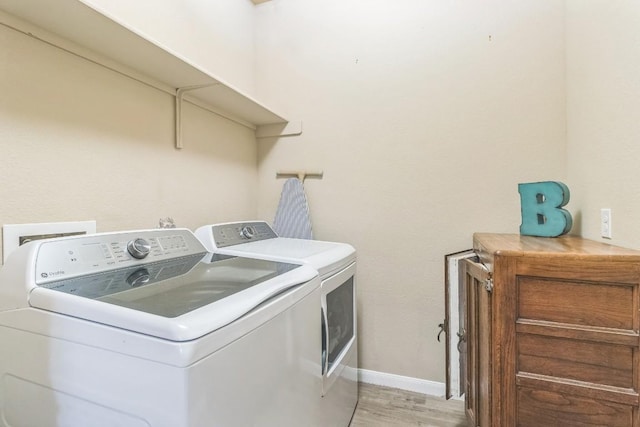 603 Luna Vista Dr, Hutto, TX 78634 - laundry area featuring separate washer and dryer and light wood-style flooring