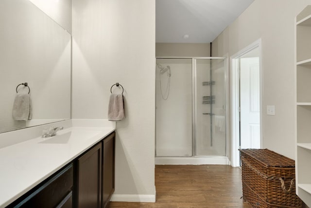 603 Luna Vista Dr, Hutto, TX 78634 - full bathroom featuring a shower stall, vanity, and wood finished floors