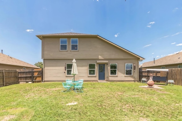 603 Luna Vista Dr, Hutto, TX 78634 - rear view of house featuring a fenced backyard and an outdoor fire pit