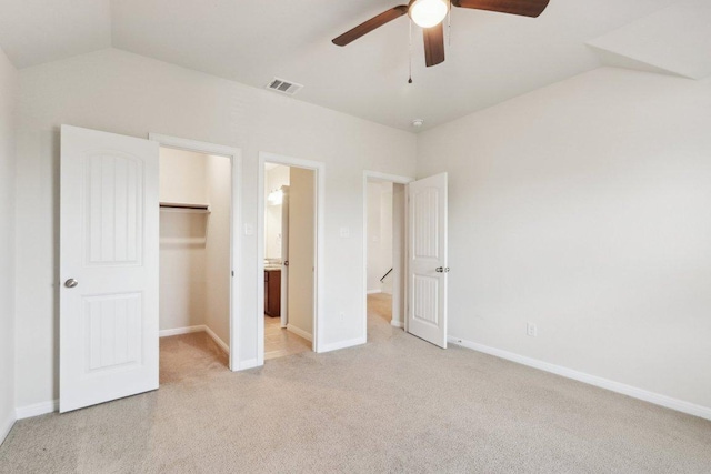 20025 Rhiannon Ln, Pflugerville, TX 78660 - unfurnished bedroom featuring vaulted ceiling, light carpet, a walk in closet, a closet, and ceiling fan