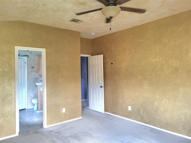 1013 Henderson Dr, Leander, TX 78641 - unfurnished bedroom with connected bathroom, lofted ceiling, carpet floors, a textured wall, and a ceiling fan
