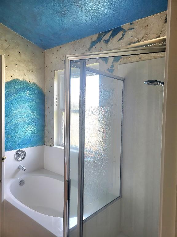 1013 Henderson Dr, Leander, TX 78641 - full bathroom featuring a bath, a stall shower, wallpapered walls, and a textured ceiling