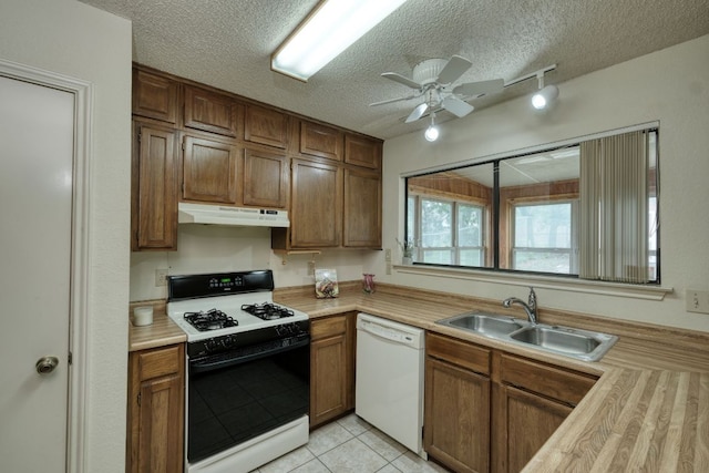13116 Billiem Dr, Austin, TX 78727 - kitchen with white appliances, under cabinet range hood, a textured ceiling, light countertops, and ceiling fan
