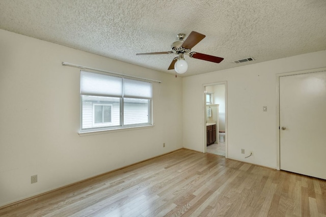 13116 Billiem Dr, Austin, TX 78727 - empty room with light wood-style flooring, ceiling fan, and a textured ceiling