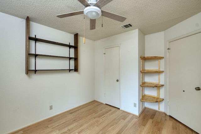 13116 Billiem Dr, Austin, TX 78727 - unfurnished bedroom with a textured ceiling, wood finished floors, and ceiling fan