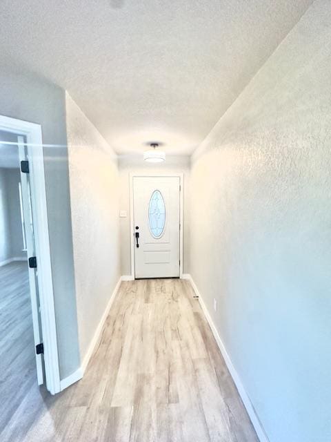 1237 Pelican Pl, New Braunfels, TX 78130 - doorway with a textured ceiling and light wood-style flooring
