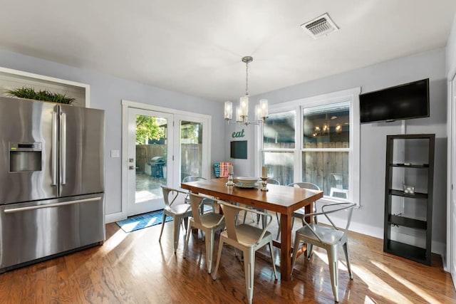 611 W Johanna St, Austin, TX 78704 - dining room with wood finished floors and a chandelier