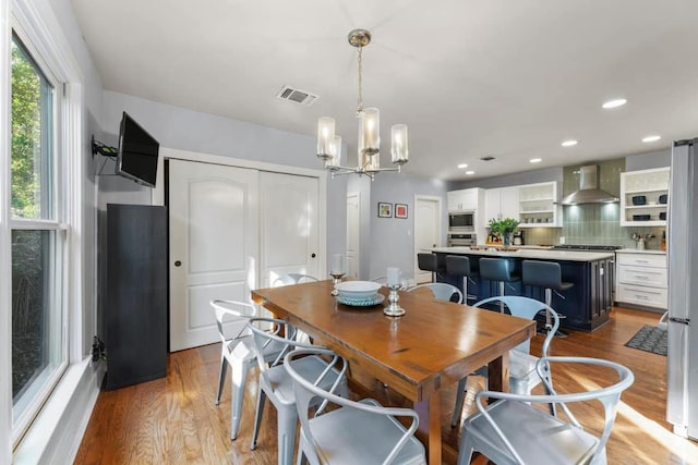 611 W Johanna St, Austin, TX 78704 - dining area featuring light wood finished floors, a chandelier, and recessed lighting