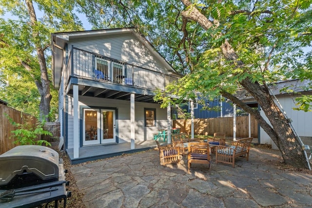 611 W Johanna St, Austin, TX 78704 - back of house with a fenced backyard, french doors, a patio, and a balcony