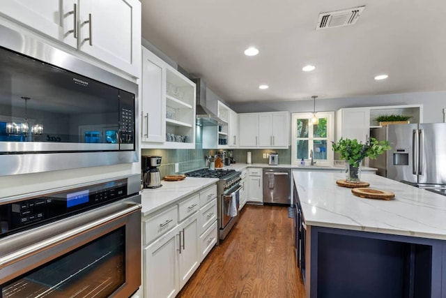 611 W Johanna St, Austin, TX 78704 - kitchen with appliances with stainless steel finishes, open shelves, dark wood-type flooring, white cabinetry, and recessed lighting