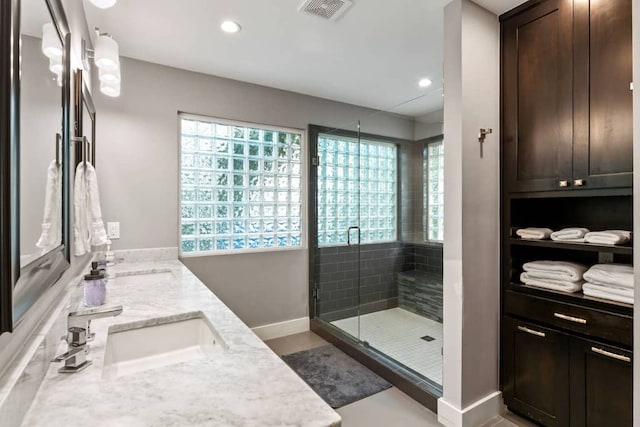 611 W Johanna St, Austin, TX 78704 - bathroom featuring double vanity, a stall shower, and recessed lighting