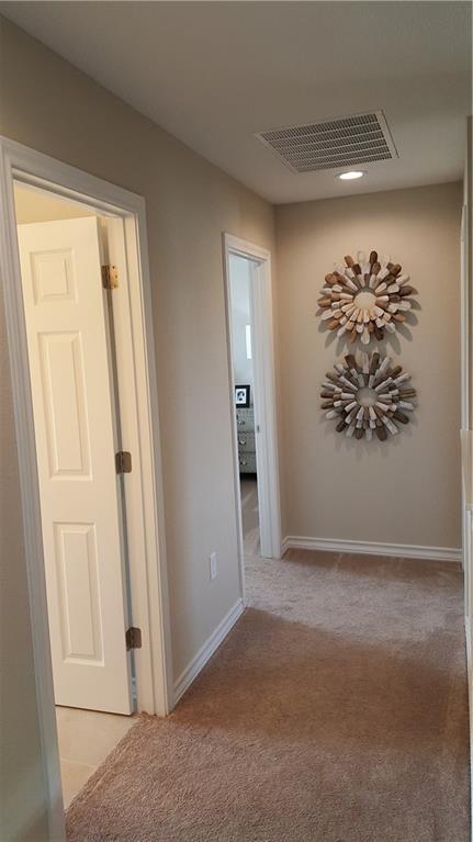 10909 Mickelson Dr, Austin, TX 78747 - hall featuring light colored carpet and baseboards