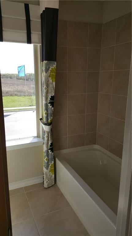 10909 Mickelson Dr, Austin, TX 78747 - bathroom featuring tile patterned floors and shower / bathtub combination with curtain