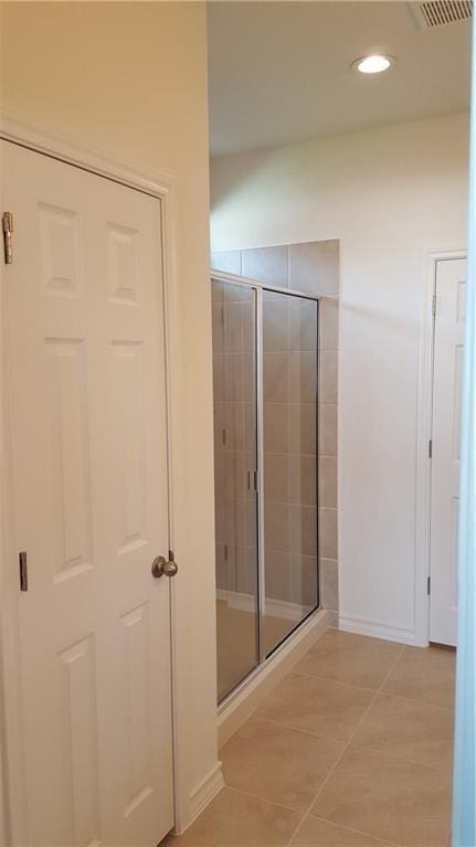 10909 Mickelson Dr, Austin, TX 78747 - bathroom featuring a stall shower, tile patterned floors, and recessed lighting