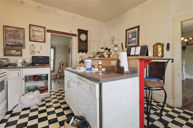 203 Grover St, Ellinger, TX 78938 - kitchen with tile patterned floors, white dishwasher, white cabinets, and dark countertops