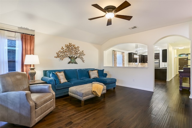 18708 Moreto Loop, Pflugerville, TX 78660 - living area with ceiling fan, dark wood-style flooring, arched walkways, vaulted ceiling, and healthy amount of natural light