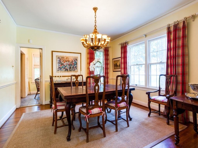 2611 Woodmont Ave, Austin, TX 78703 - dining area featuring a chandelier, plenty of natural light, crown molding, and wood finished floors