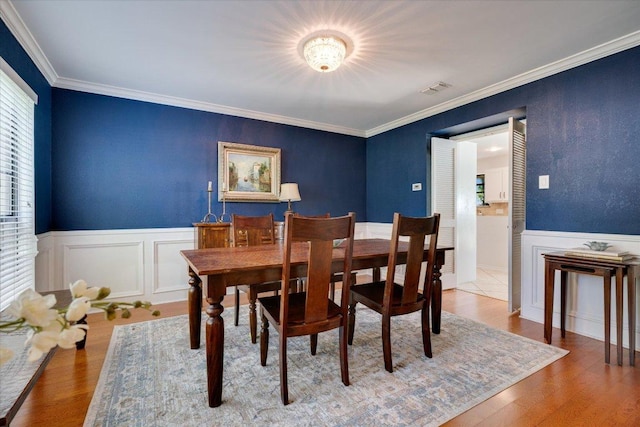 9410 Topridge Dr, Austin, TX 78750 - dining room with wainscoting, ornamental molding, wood finished floors, and a decorative wall