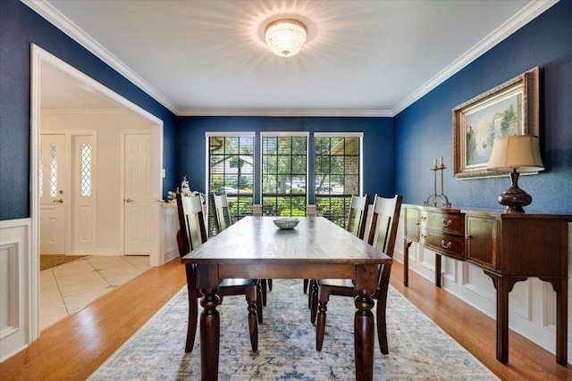 9410 Topridge Dr, Austin, TX 78750 - dining space with crown molding, wood finished floors, and a wainscoted wall