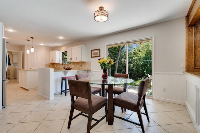 9410 Topridge Dr, Austin, TX 78750 - dining area with light tile patterned floors, wainscoting, and recessed lighting