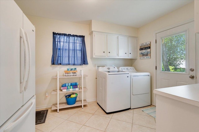 9410 Topridge Dr, Austin, TX 78750 - washroom with cabinet space, washing machine and clothes dryer, and light tile patterned flooring