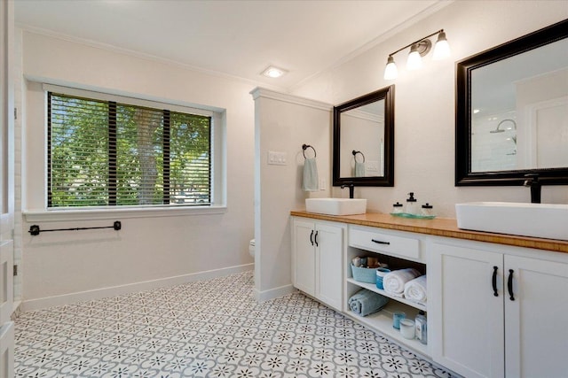 9410 Topridge Dr, Austin, TX 78750 - bathroom featuring ornamental molding and double vanity
