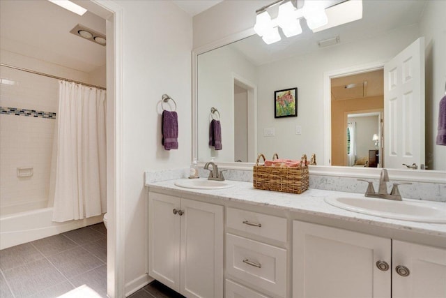 9410 Topridge Dr, Austin, TX 78750 - full bathroom with double vanity, shower / bath combo, and tile patterned flooring